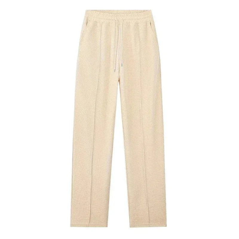 Pantalón beige de tela ligera con cintura elástica y cordón, estilo casual para mujer