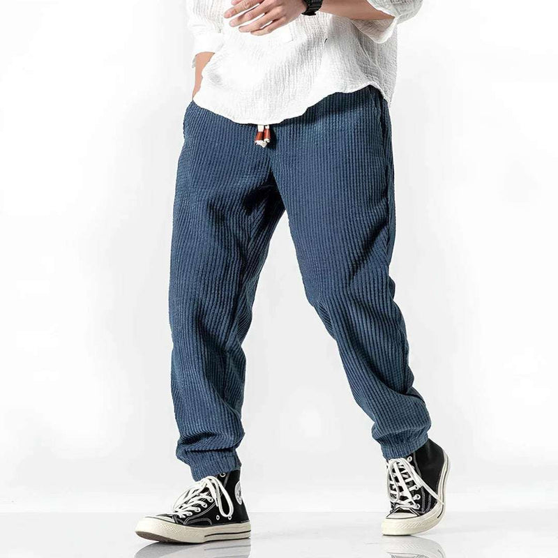 Pantalón jogger azul de pana para hombre, estilo casual, con cordón ajustable y textura acanalada.