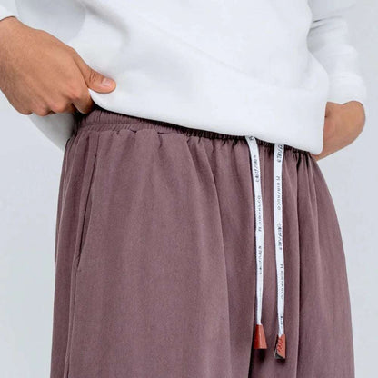 Pantalón gris suelto de cintura elástica con cordón ajustable y bolsillos, ropa casual