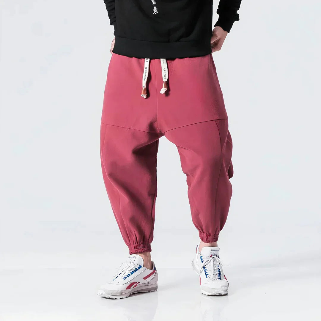 Pantalón jogger rojo para hombre con cordón y puños elásticos, calzado deportivo blanco